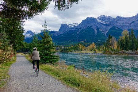 Rear View of Woman Walking on Mountain Road