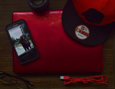 Red and Black New Era 9fifty Snapback Cap and Black Samsung Galaxy Android Smartphone