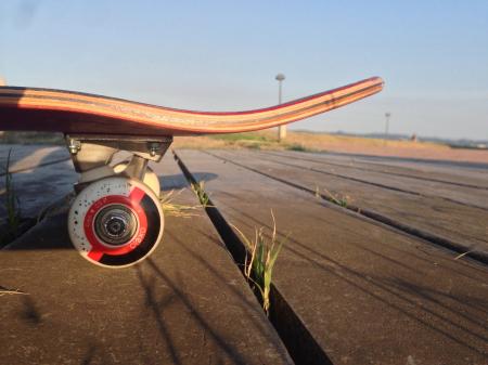 Red and Brown Skateboard on Gray Road