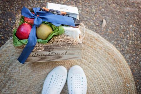 Red and Green Fruits Beside White Box on Brown Wooden Box