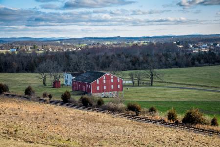 Red And Grey House In The Middle Of Green Grass Field
