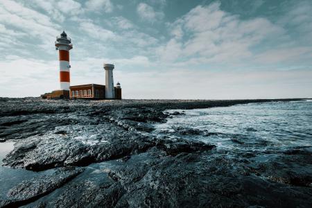 Red and White Lighthouse on Land