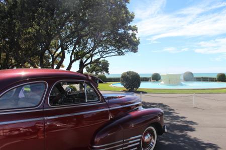 Red Classic Car Parked Near Tree during Daytime