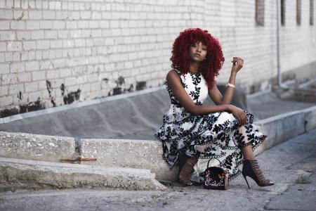 Red Haired Woman in White and Black Floral Sleeveless Maxi Dress