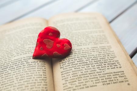 Red heart on a old opened book