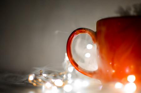 Red Mug Beside String Lights