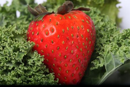 Red Strawberry on kale