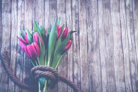 Red Tulip Bouquet on Top of Brown Wooden Surface