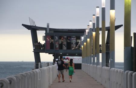 Restaurant on the pier and walking couple