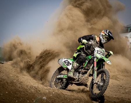 Rider Riding Green Motocross Dirt Bike