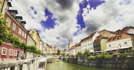 River Near Building Under White Grey and Blue Sky during Dayime