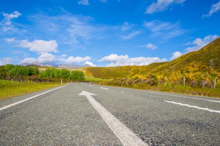 Road Passing Through Landscape Against Blue Sky