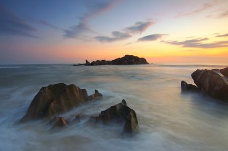 Rock Formation on Body of Water during Golden Hour