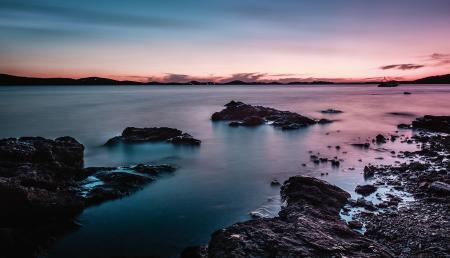 Rock Formation On Body Of Water During Golden Hour