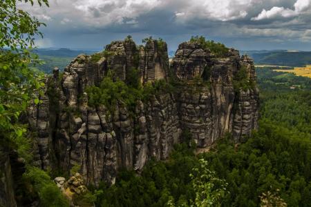 Rock Formation Surrounded by Green Trees during Humid Weather