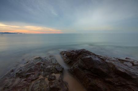 Rock Formation Surrounded by Sea during Daytime