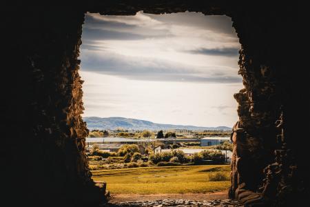 Rock Formation With Grassfield Background