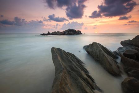 Rock Near a White Foggy Area Under an Orange Sky