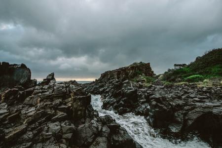 Rocky River Under Cloudy Sky