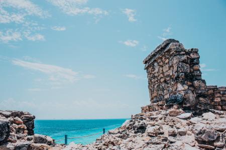 Rocky Terrain Near Sea Under Blue Skies