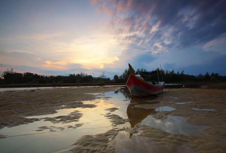 Rowing Boat in Body of Water Under Blue Sky and White Clouds during Daytime