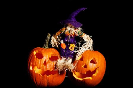 Scarecrow sitting on Pumpkins