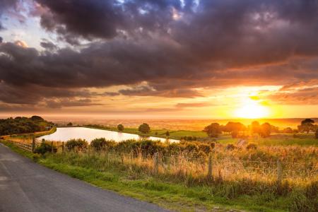 Scenic View of Agricultural Field Against Dramatic Sky