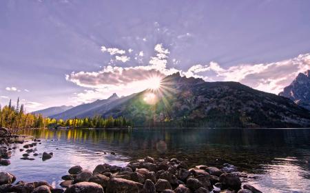 Scenic View of Lake by Mountains Against Sky at Night