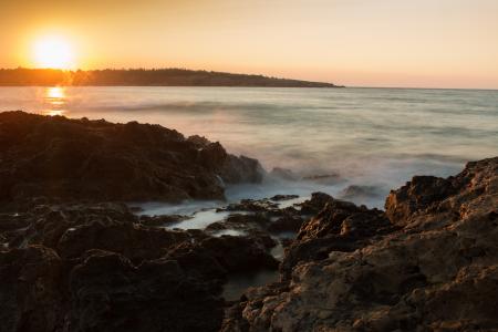 Scenic View of Sea Against Dramatic Sky during Sunset