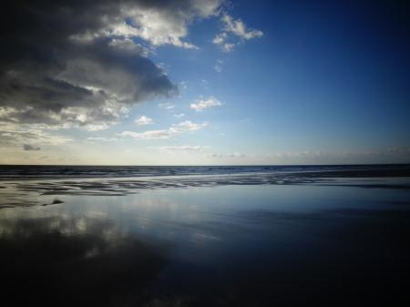 Selective Color Photography of Ocean Overlooking the Horizon Under Blue Sky during Daytime