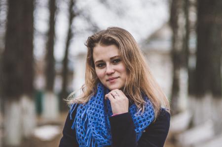 Selective Focal Photo of Woman Wearing Blue Knitted Mesh Infinity Scarf