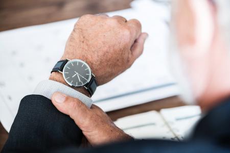 Selective Focus Photo of a Person Wearing Round Watch at 9:36