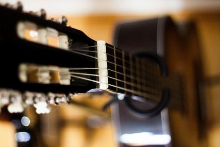 Selective Focus Photo of Black Classical Guitar