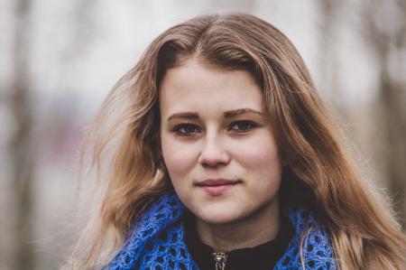 Selective Focus Photo of Woman Wearing Knitted Blue and Black Top