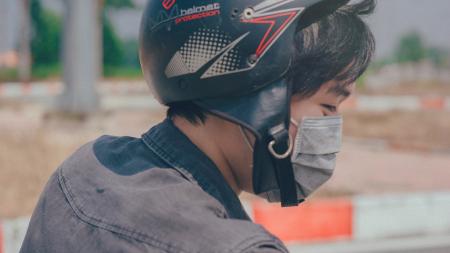 Selective Focus Photography of Person Wearing Black and Red Helmet and Gray Mask