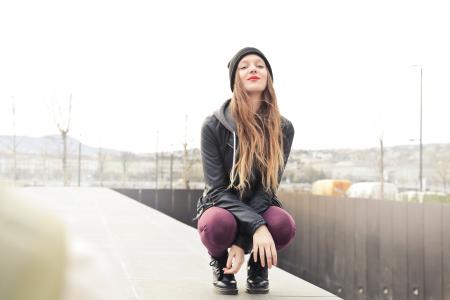 Selective Photo of Woman in Gray Hooded Jacket Doing Crouch Position