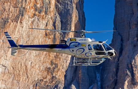 Selective Photograph of White Helicopter Near Brown Mountains