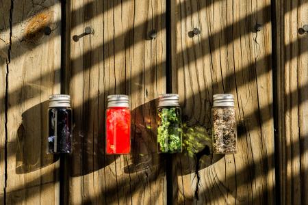 Several Assorted-color Glass Bottles on Table
