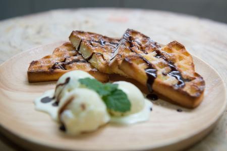 Shallow Focus Photography of Baked Bread With Chocolate Syrup Serve on Wooden Plate