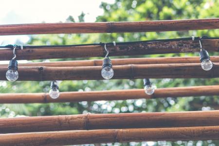 Shallow Focus Photography of Light Bulb Hanging on Brown Wooden Sticks