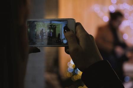 Shallow Focus Photography of Person Holding Silver Iphone 6s