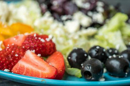 Shallow Focus Photography of Sliced Strawberries and Black Olives