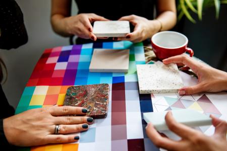 Shallow Focus Photography of Three People Holding Square Panels