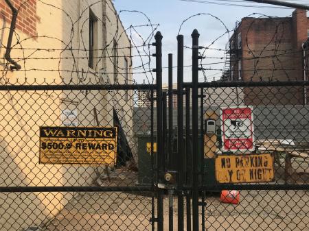 Signs and fence along W. 23rd Street between Maryland Avenue and Morton Street, Baltimore, MD