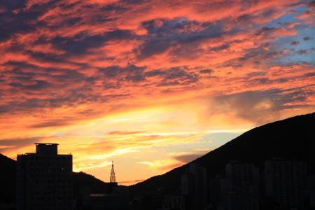 Silhouette Cityscape Against Dramatic Sky during Sunset