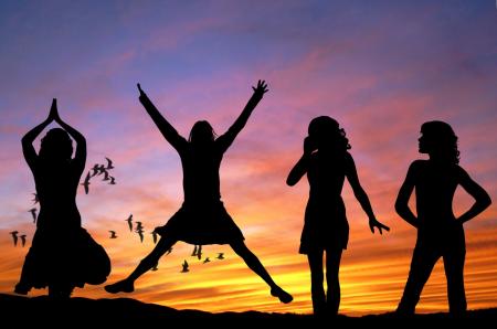 Silhouette of 4 Women With the Background of Birds Flying Under Yellow and Grey Sky