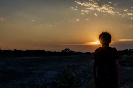 Silhouette of a Boy During Sunset