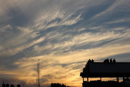 Silhouette of Building With People Standing during Golden Hour