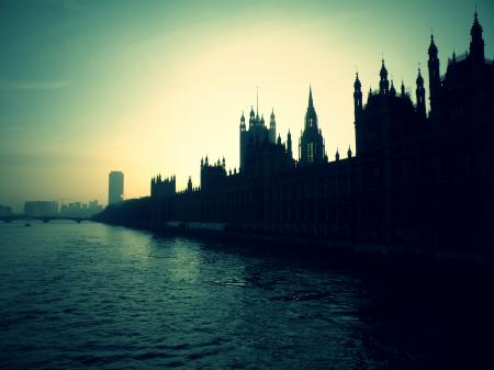 Silhouette of High Rise Buildings Beside Body of Water during Golden Hour