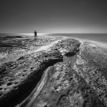 Silhouette of Man Near Body of Water